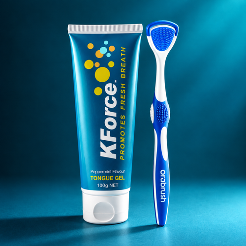 KForce Peppermint Flavor Tongue Gel 100g tube standing next to an Orbbrush manual tongue scraper on a dark blue gradient background.
