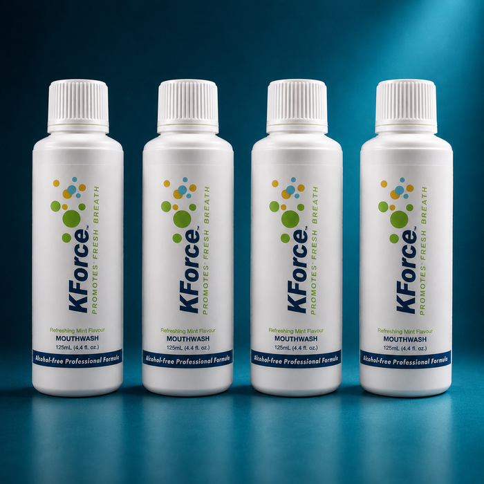 Four white bottles of KForce mouthwash arranged in a row against a dark blue gradient background. Each bottle features a white cap, a white body with blue and green branding, and a blue label at the bottom.